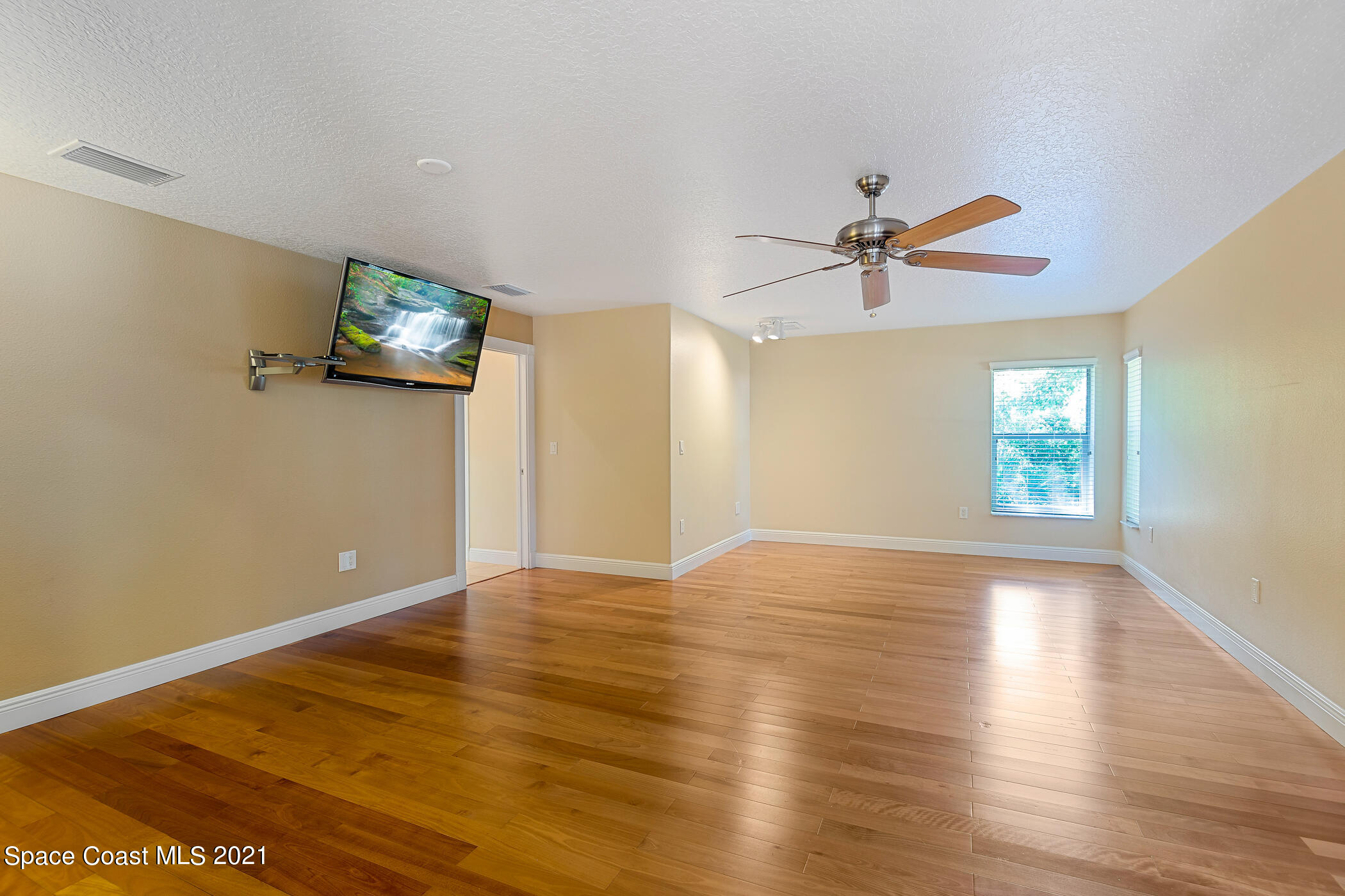 1390 Friday Road Cocoa, FL 32926 - Photo 44 of 69 an empty room with wooden floor and windows
