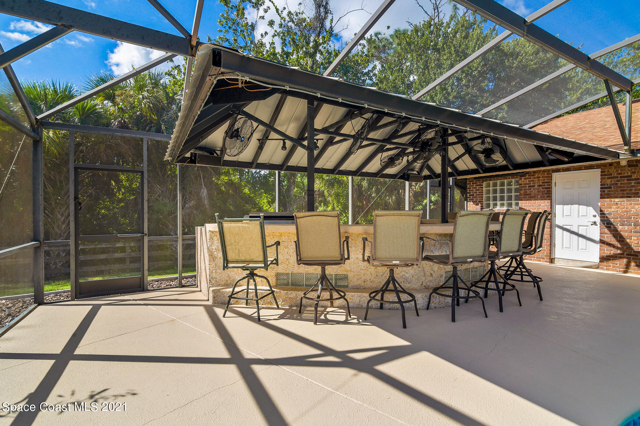1390 Friday Road Cocoa, FL 32926 - Photo 51 of 69 a view of a patio with table and chairs and potted plants