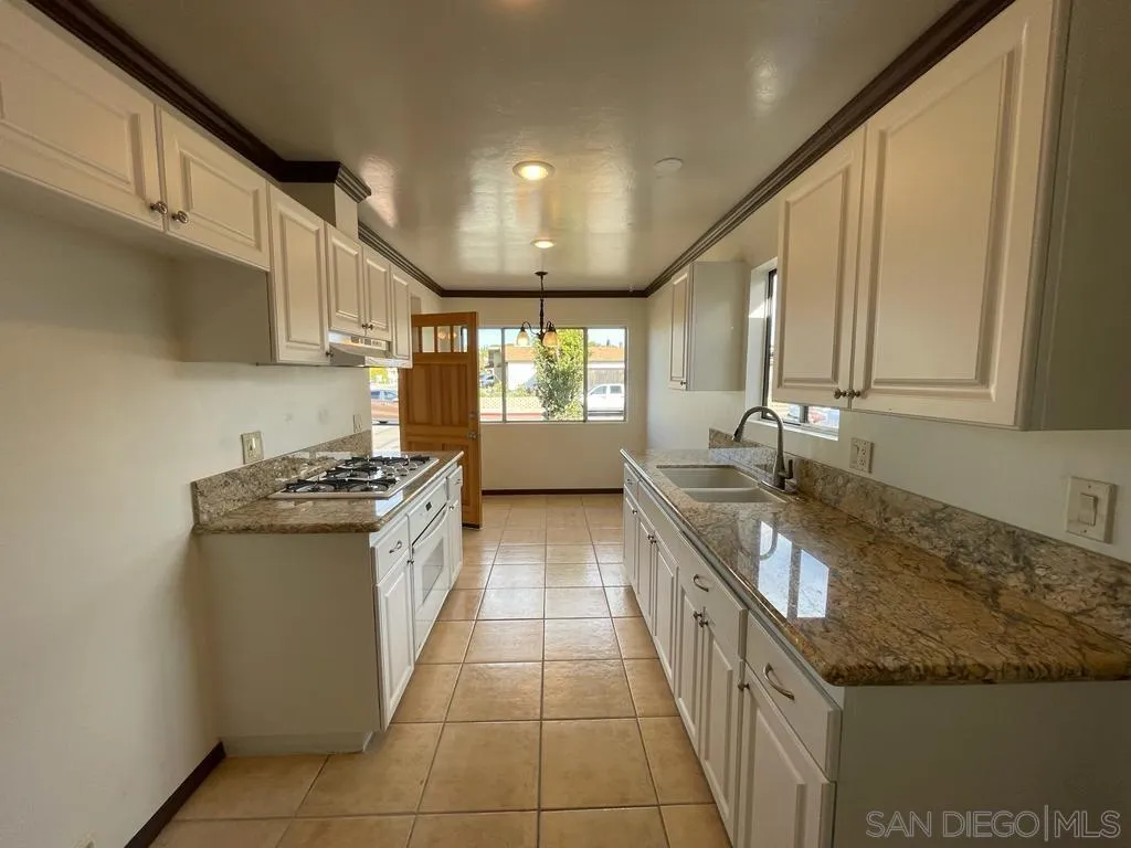 3651 North Way Oceanside, CA 92056 - Photo 3 of 16 a large kitchen with stainless steel appliances granite countertop a sink and a stove