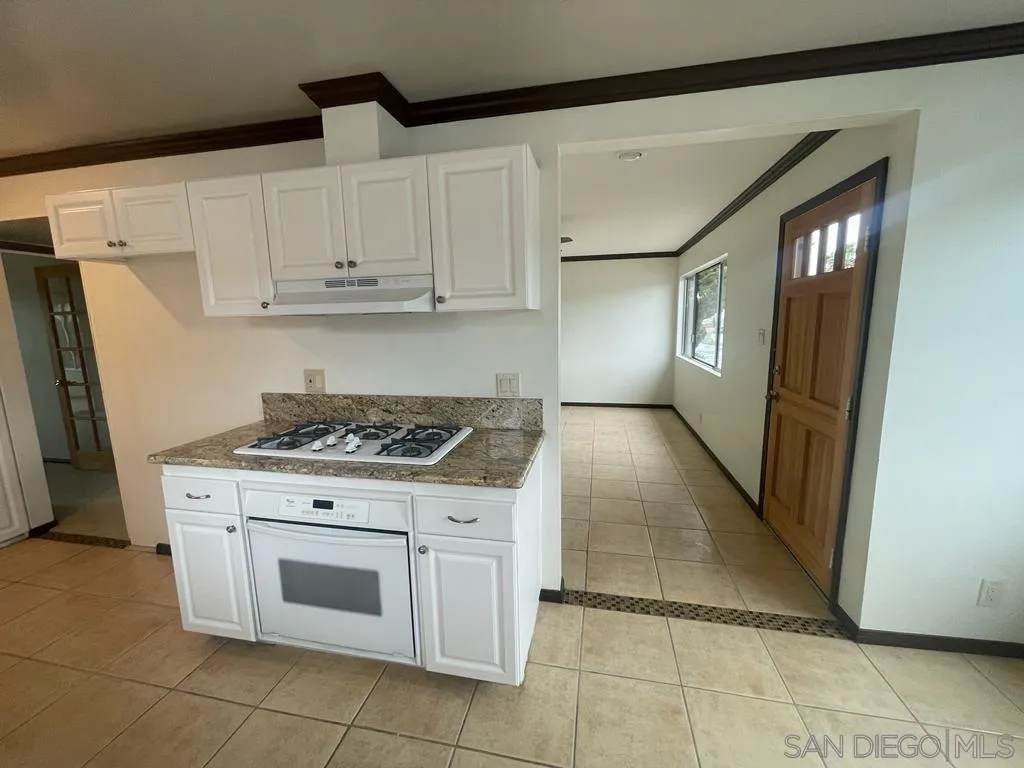 3651 North Way Oceanside, CA 92056 - Photo 4 of 16 a kitchen with a stove top oven and cabinets