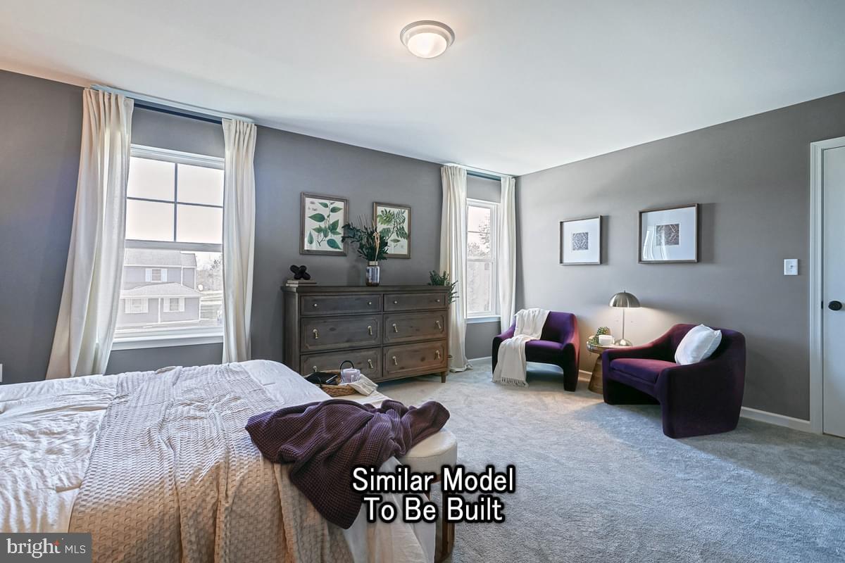 White Oak Plan At Woodlyn Preserve Selinsgrove, PA 17870 - Photo 27 of 42 a bedroom with a bed and a couch