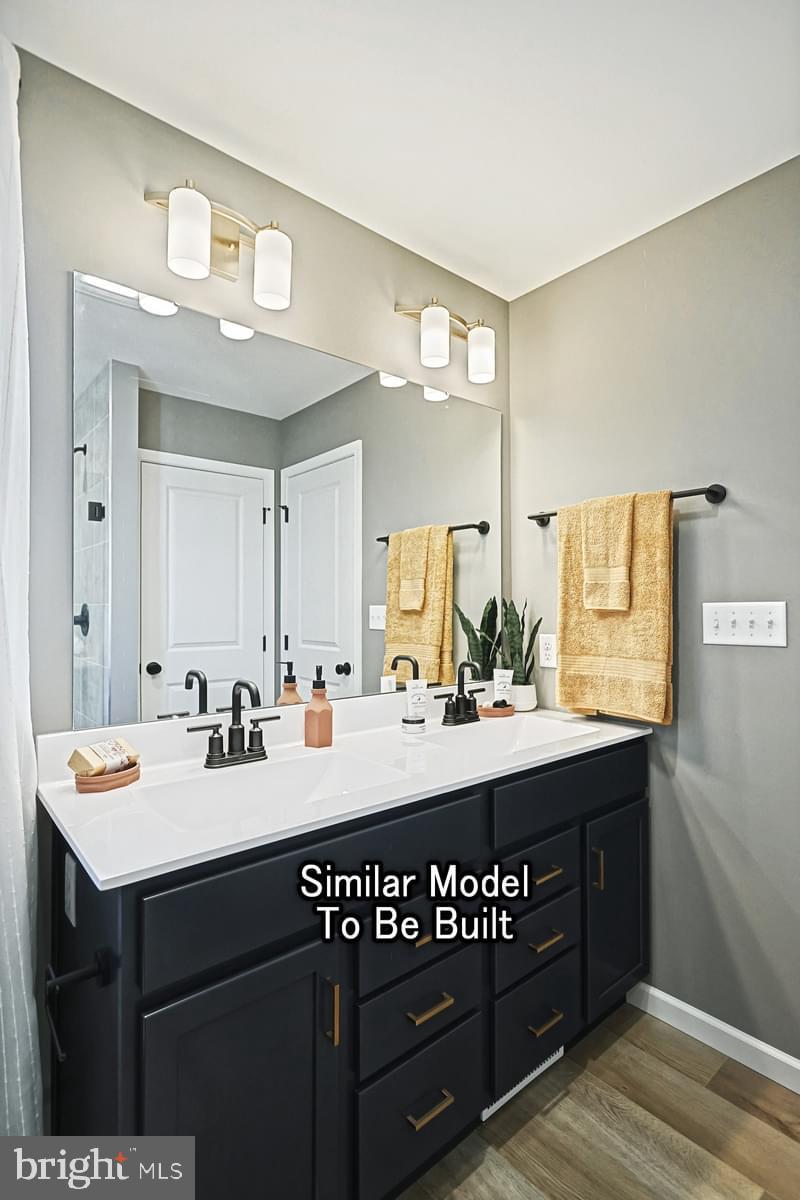 White Oak Plan At Woodlyn Preserve Selinsgrove, PA 17870 - Photo 29 of 42 a bathroom with a sink vanity and a mirror