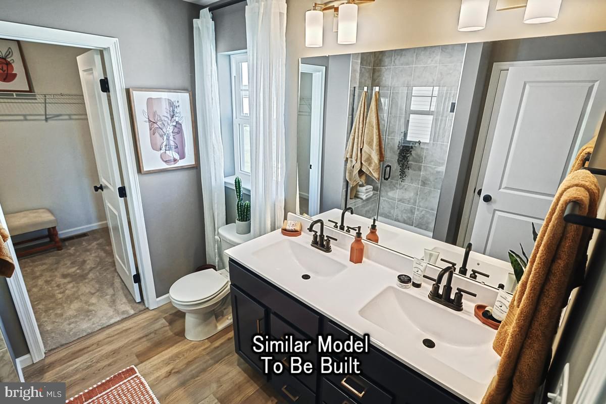 White Oak Plan At Woodlyn Preserve Selinsgrove, PA 17870 - Photo 31 of 42 a bathroom with a sink mirror vanity and toilet