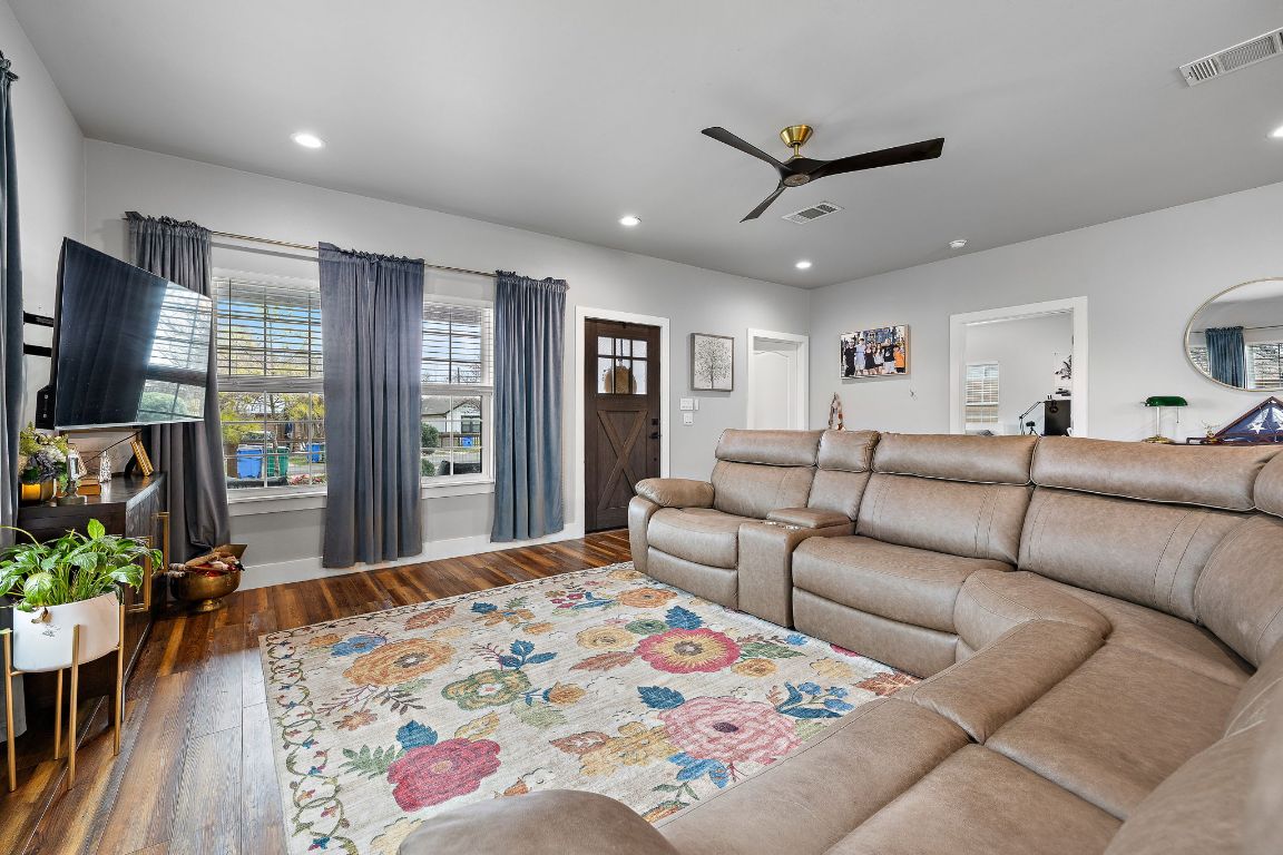 611 Elliott Street Taylor, TX 76574 - Photo 11 of 29 a living room with furniture ceiling fan and a flat screen tv