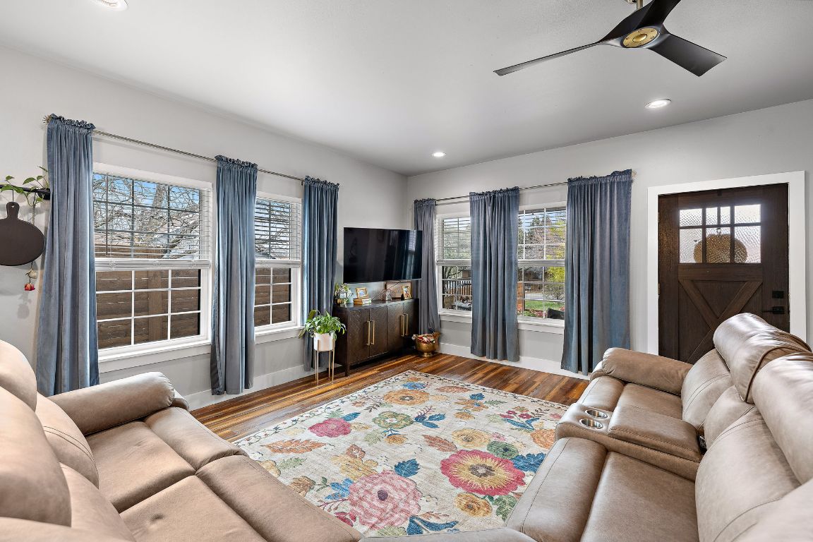 611 Elliott Street Taylor, TX 76574 - Photo 12 of 29 a bedroom with a balcony a bed and a couch