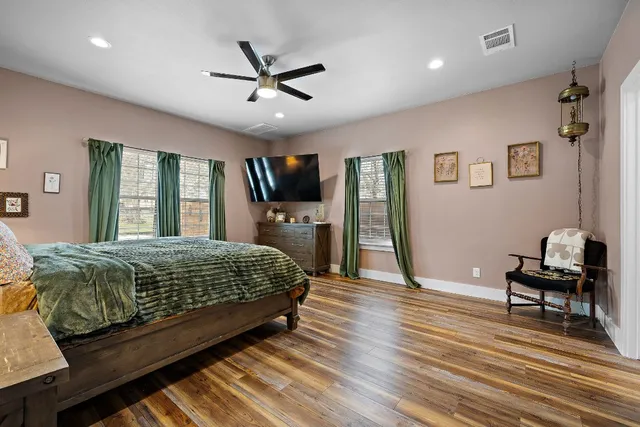 a bedroom with a bed and a chandelier