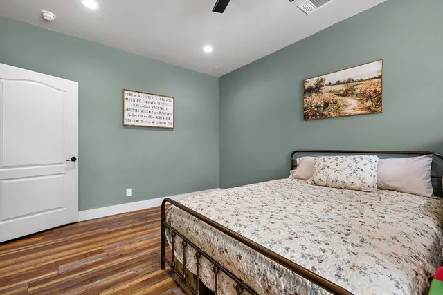 a bedroom with a bed and a painting on the wall