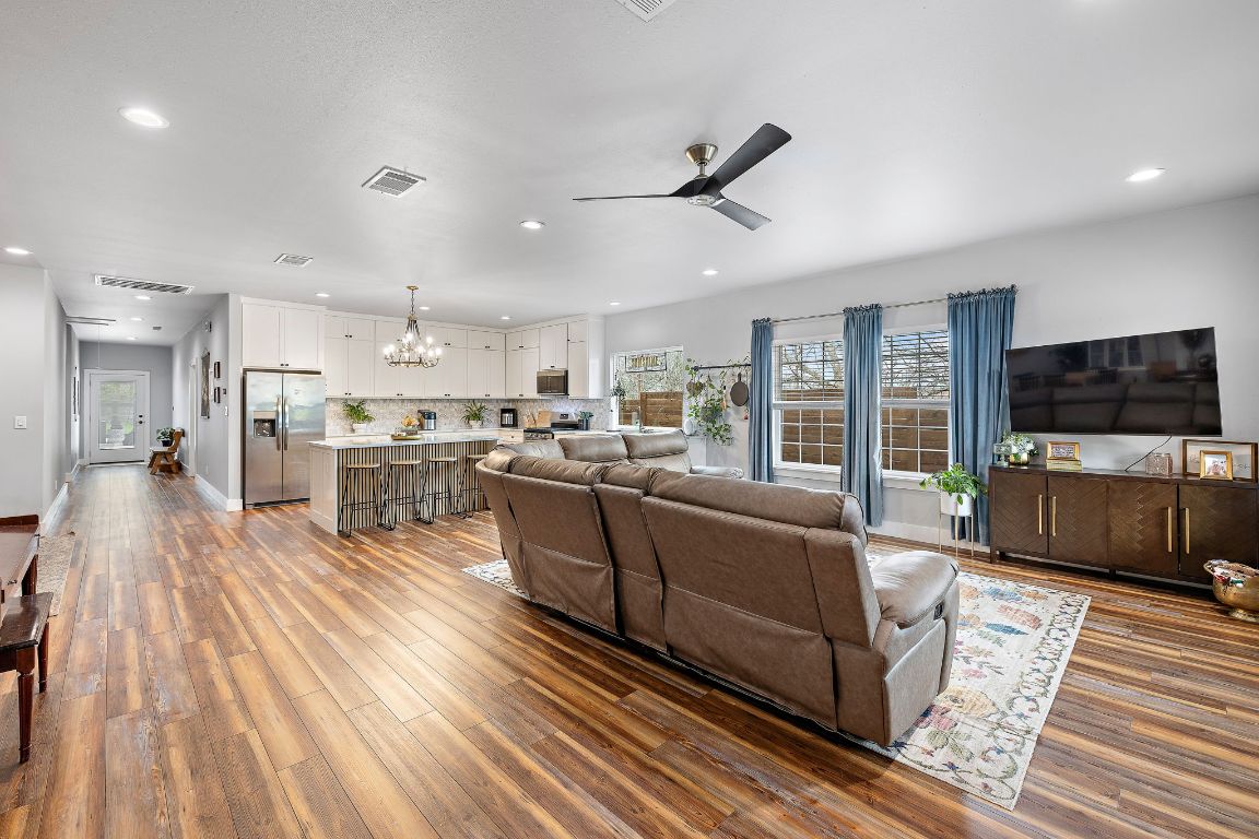 611 Elliott Street Taylor, TX 76574 - Photo 3 of 29 a living room with stainless steel appliances furniture wooden floor and a kitchen view