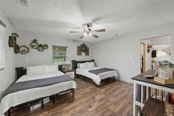 a spacious bedroom with a bed and a couch