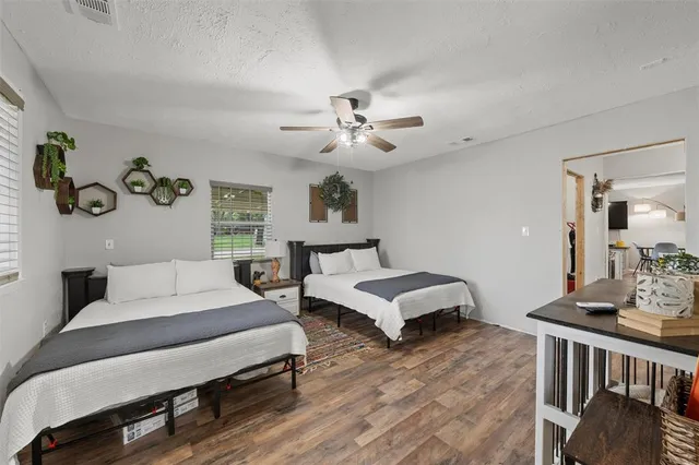 a spacious bedroom with a bed and a couch