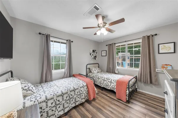a bedroom with a bed and a chandelier