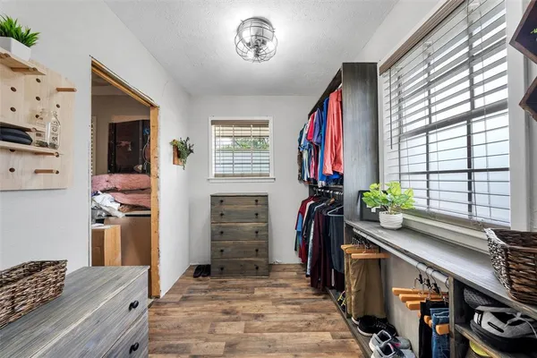 a view of a livingroom with furniture and a hallway