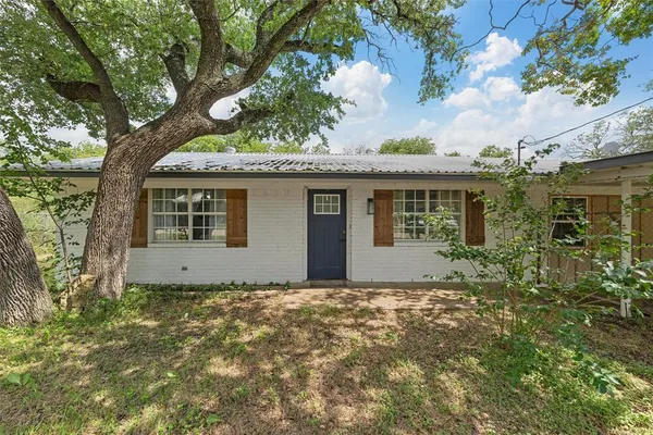 a house with a tree in the background