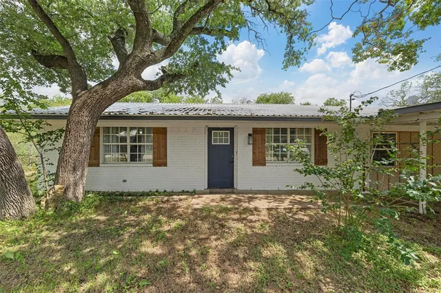 a house with a tree in the background