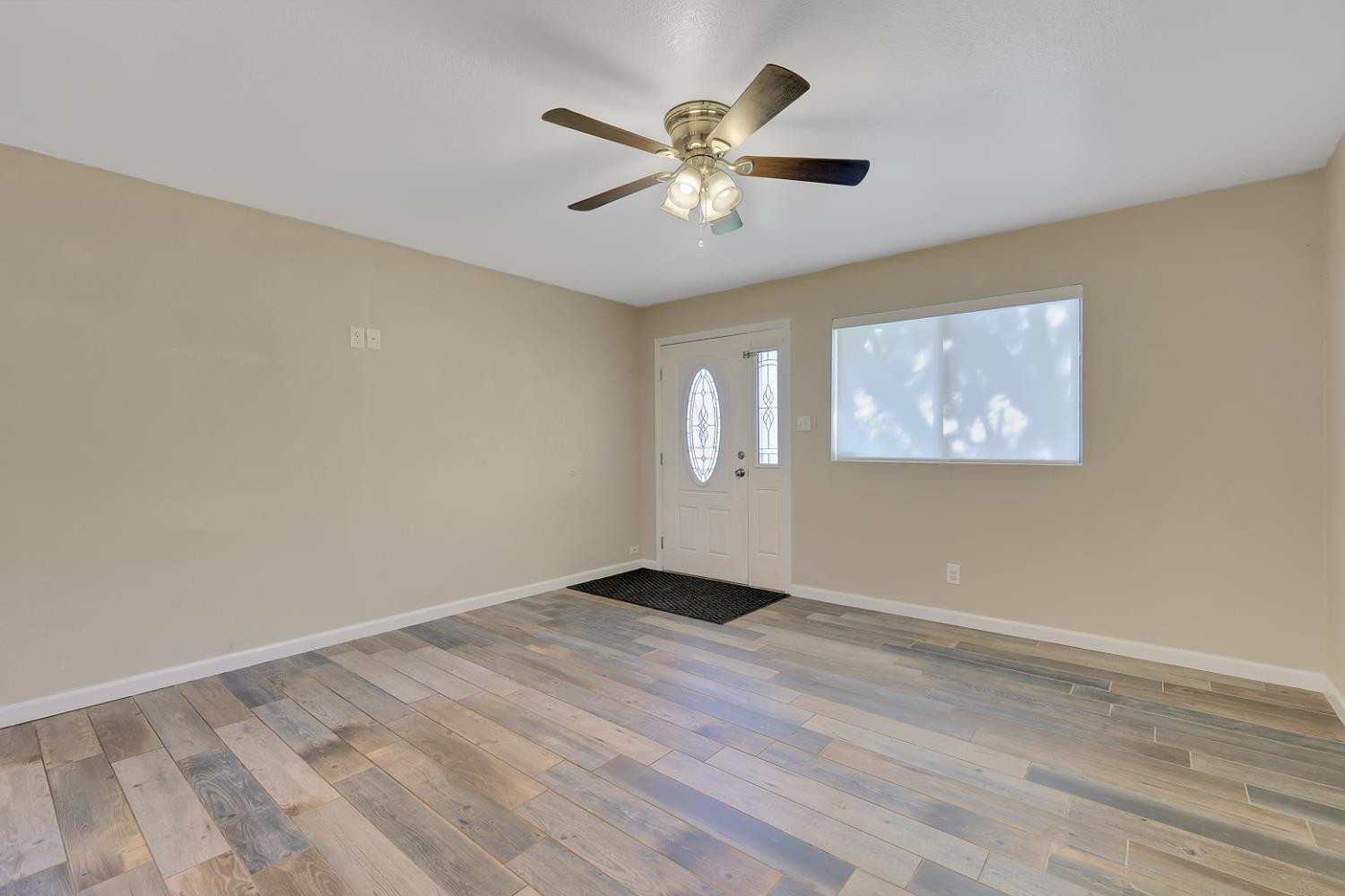 2130 Palm Street Sutter, CA 95982 - Photo 4 of 27 wooden floor in an empty room with a window
