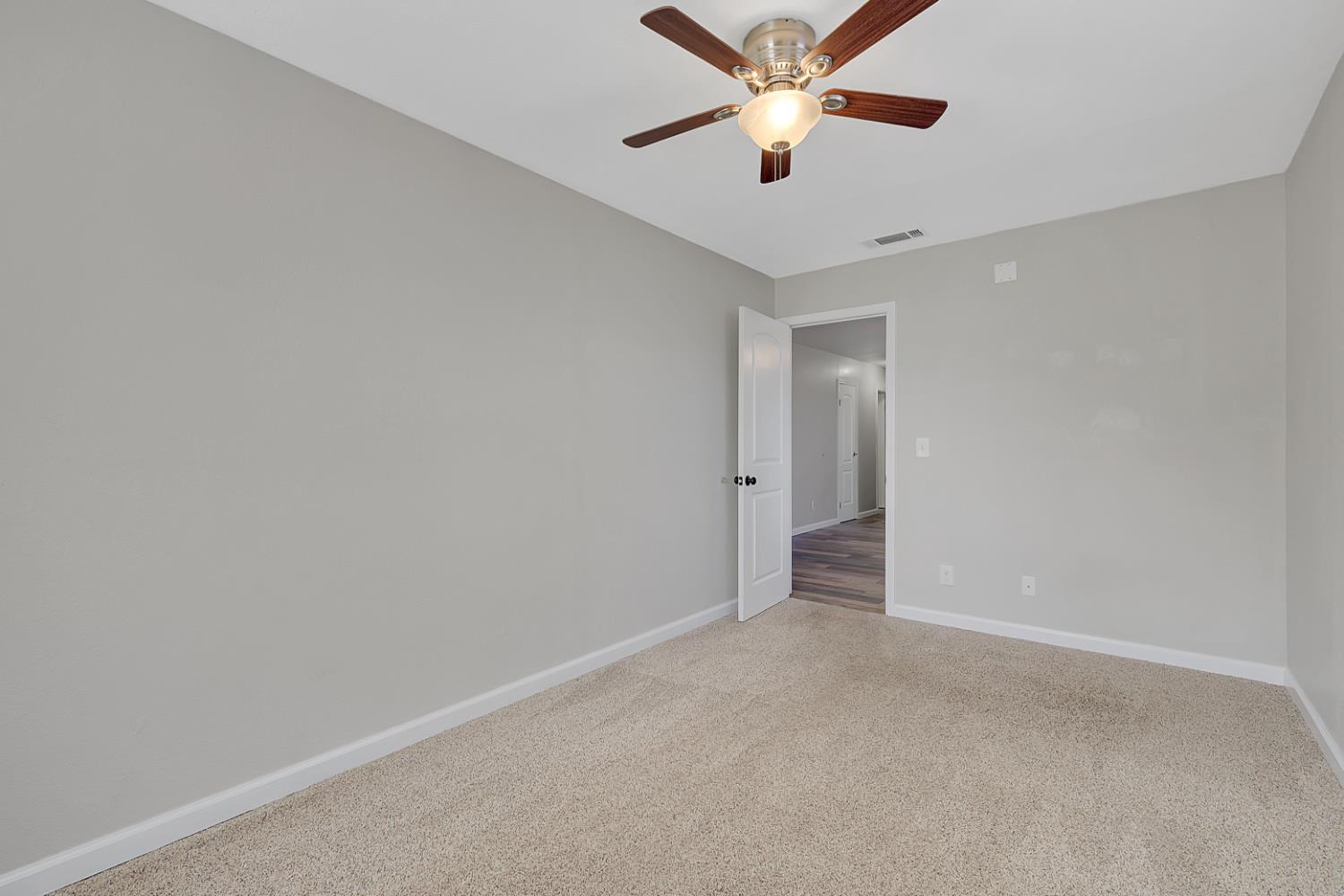 2130 Palm Street Sutter, CA 95982 - Photo 8 of 27 an empty room with closet and a ceiling fan