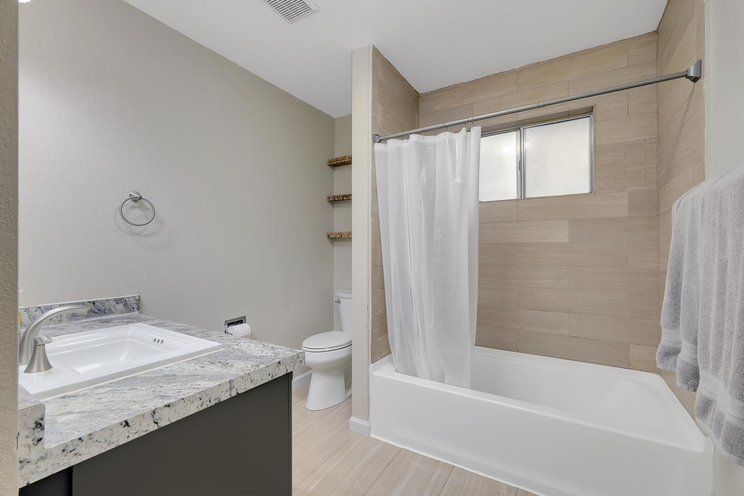 2130 Palm Street Sutter, CA 95982 - Photo 10 of 27 a bathroom with a granite countertop sink toilet and bathtub