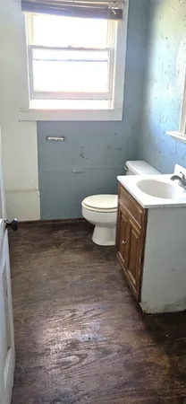 a bathroom with a sink a toilet and window