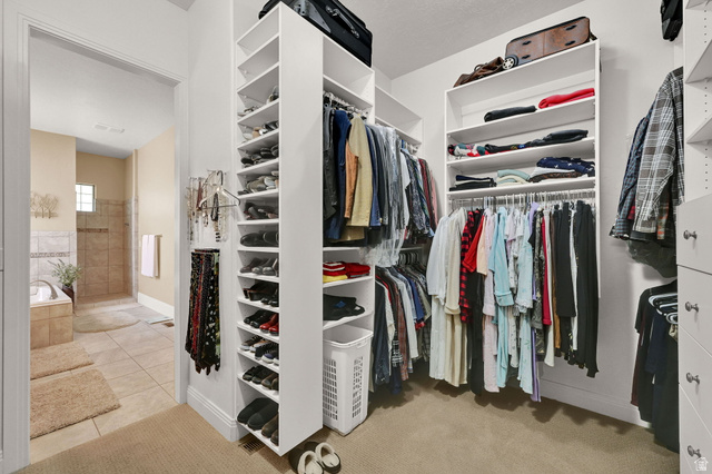 1926 East Gray Fox Drive Draper, UT 84020 - Photo 16 of 31 Expansive walk-in closet with extensive built-in shelving, multiple hanging rods, dedicated shoe storage, and this only shows half of it.