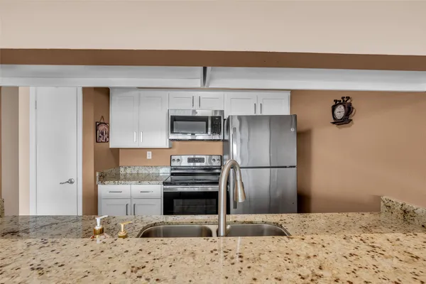a kitchen with a refrigerator and a stove