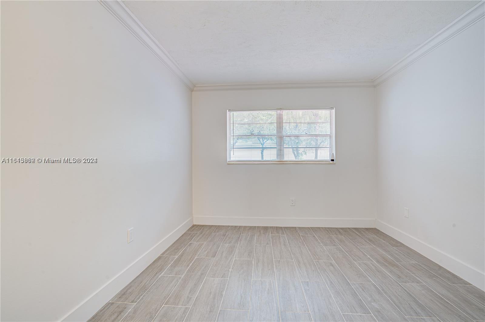 3019 Southwest 68th Terrace, Unit 6 Miramar, FL 33023 - Photo 2 of 10 an empty room with a window