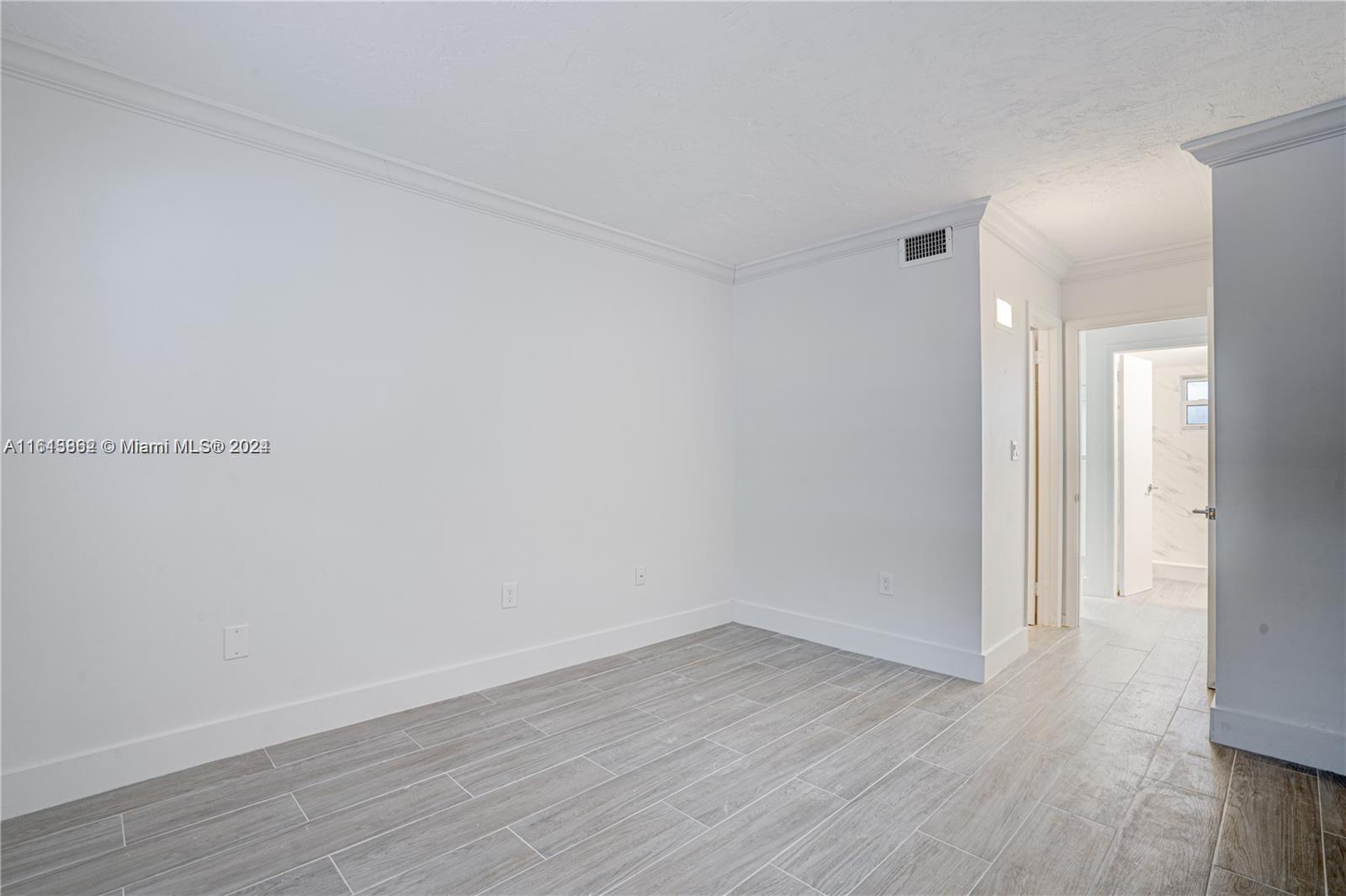 3019 Southwest 68th Terrace, Unit 6 Miramar, FL 33023 - Photo 3 of 10 a view of an empty room with wooden floor