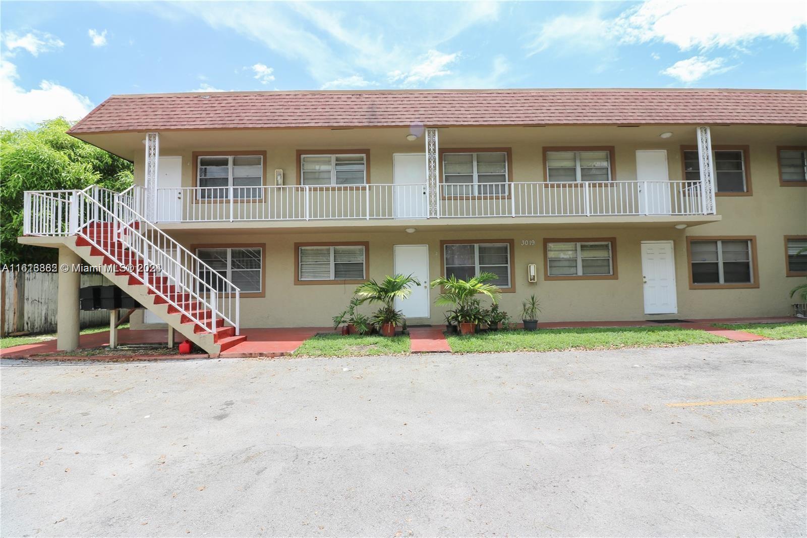 3019 Southwest 68th Terrace, Unit 6 Miramar, FL 33023 - Photo 7 of 10 a front view of a house with a yard