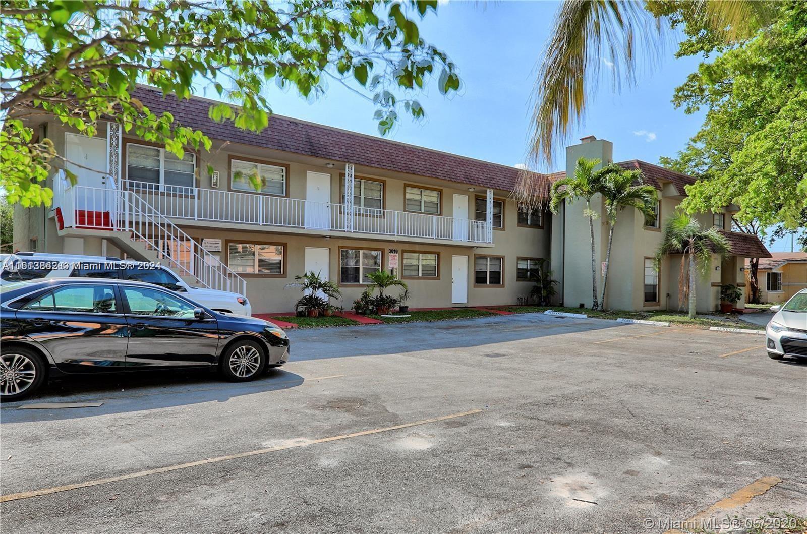 3019 Southwest 68th Terrace, Unit 6 Miramar, FL 33023 - Photo 8 of 10 a car parked in front of a building