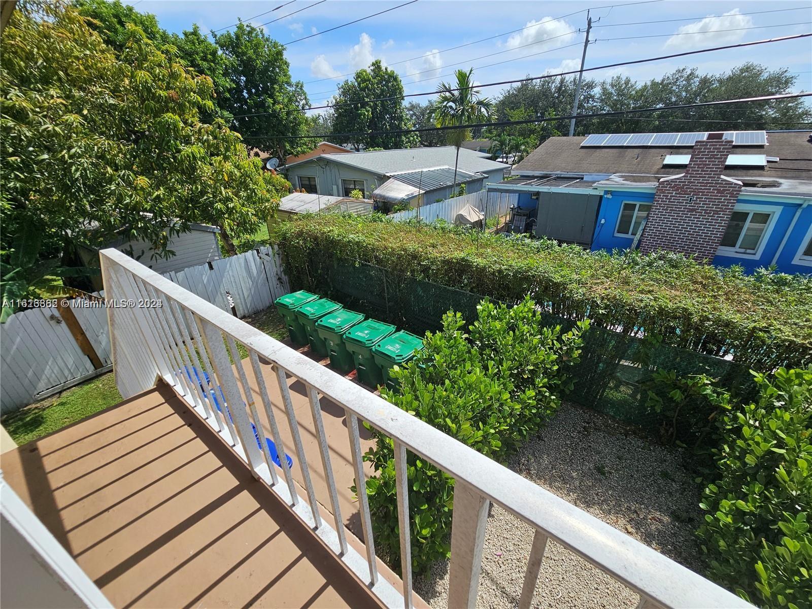 3019 Southwest 68th Terrace, Unit 6 Miramar, FL 33023 - Photo 9 of 10 a view of a balcony with wooden fence