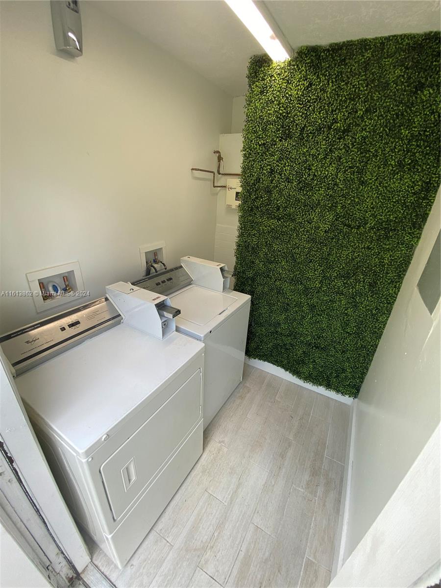 3019 Southwest 68th Terrace, Unit 6 Miramar, FL 33023 - Photo 10 of 10 a bath tub sitting in a bathroom next to a white wall