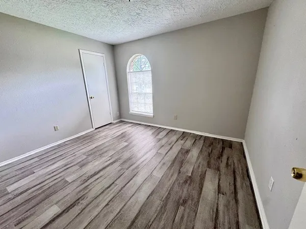 a view of wooden floor with window in a room