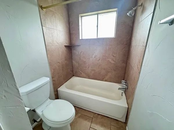 a bathroom with a toilet and a bathtub