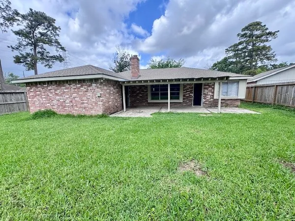 a view of a house with a garden and deck
