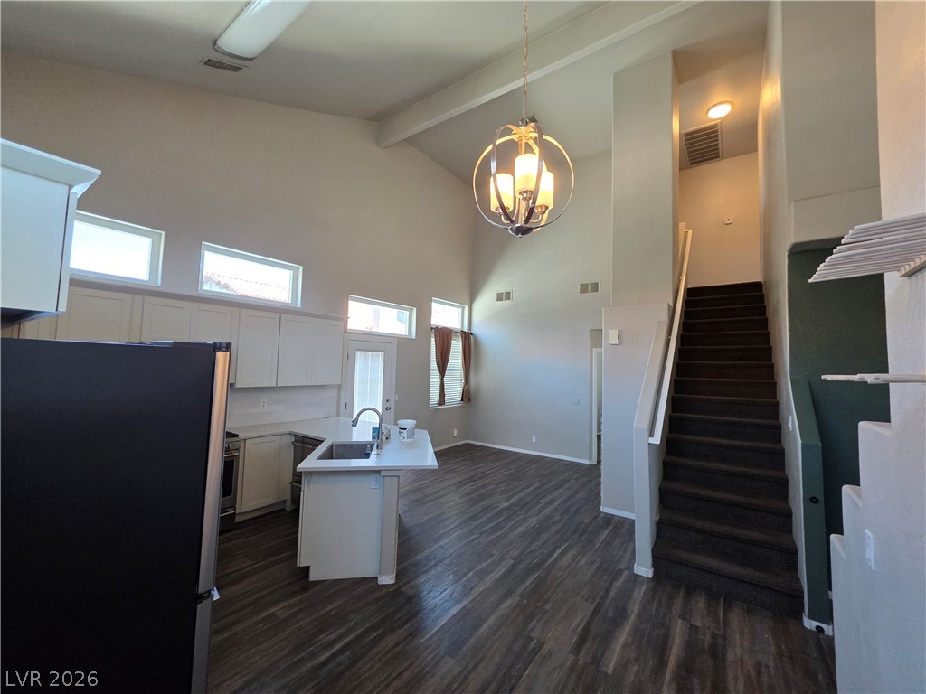 2275 Ramsgate Drive Henderson, NV 89074 - Photo 30 of 84 Lofty ceilings complement a modern kitchen island and elegant lighting in this versatile living space.