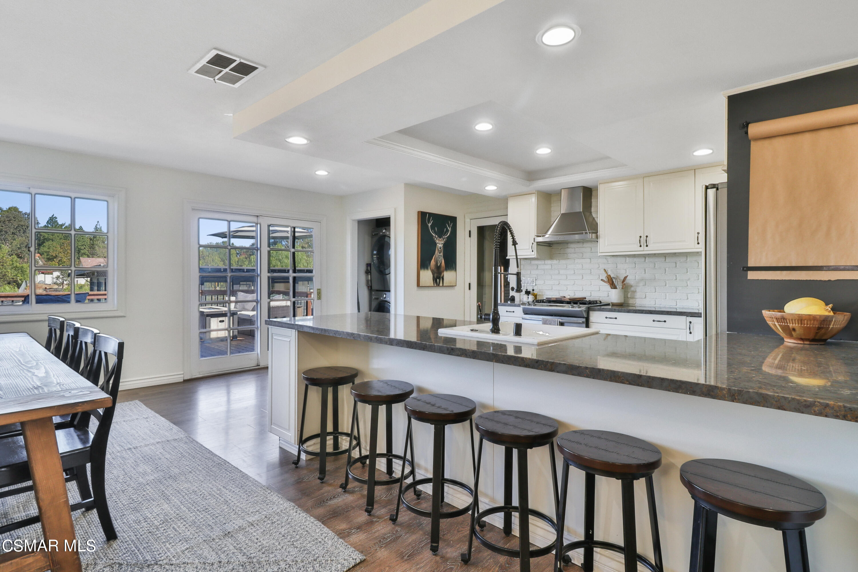 1193 Nonchalant Drive Simi Valley, CA 93065 - Photo 36 of 82 a kitchen with counter space dining table and chairs