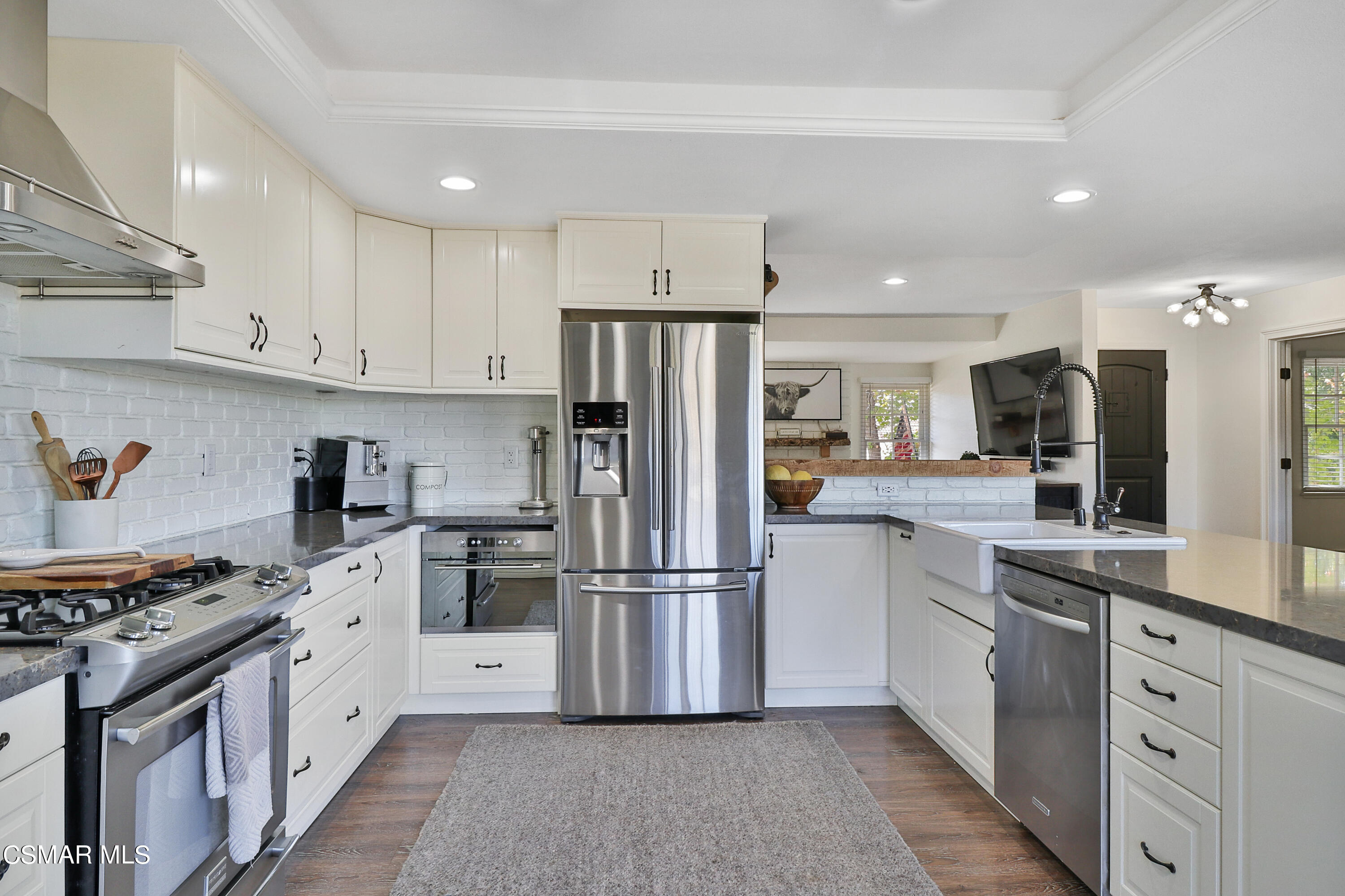 1193 Nonchalant Drive Simi Valley, CA 93065 - Photo 40 of 82 a kitchen with white cabinets and stainless steel appliances
