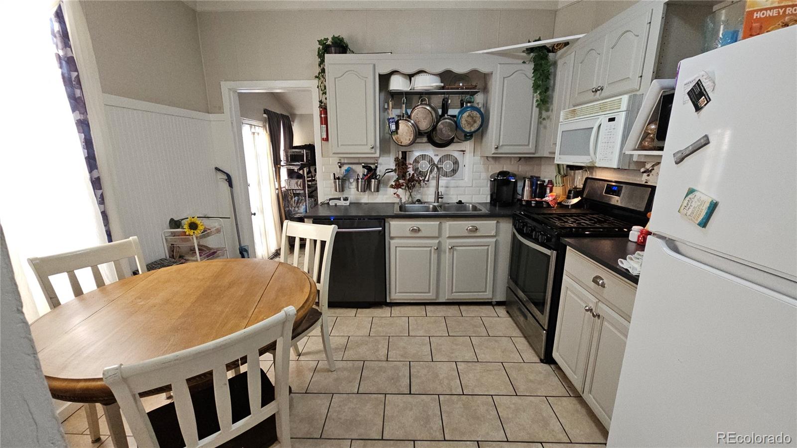402 East Routt Avenue Pueblo, CO 81004 - Photo 5 of 9 a kitchen with stainless steel appliances granite countertop a sink and cabinets
