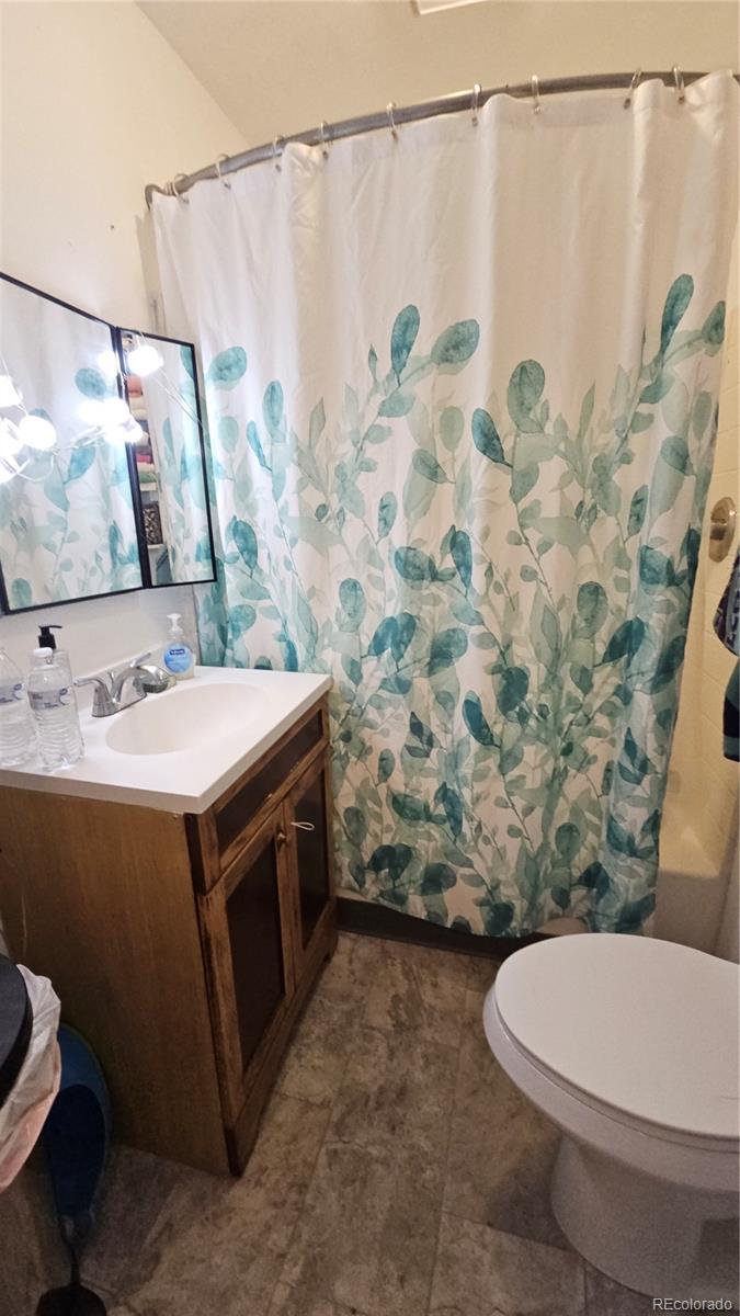 402 East Routt Avenue Pueblo, CO 81004 - Photo 9 of 9 a bathroom with a sink and a mirror