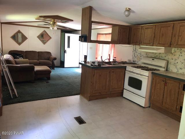 213 Slish Road Honesdale, PA 18431 - Photo 8 of 13 a kitchen with stainless steel appliances granite countertop a stove a sink and a microwave
