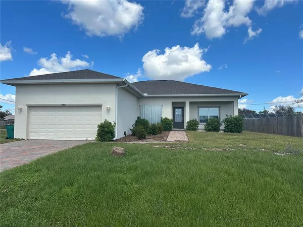a view of a house with a yard and plants