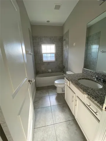 an empty room with sliding door and mirror