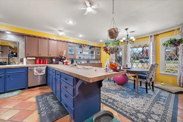 a kitchen with a sink stove and large window