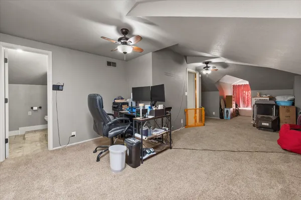a view of a livingroom with workspace and a window