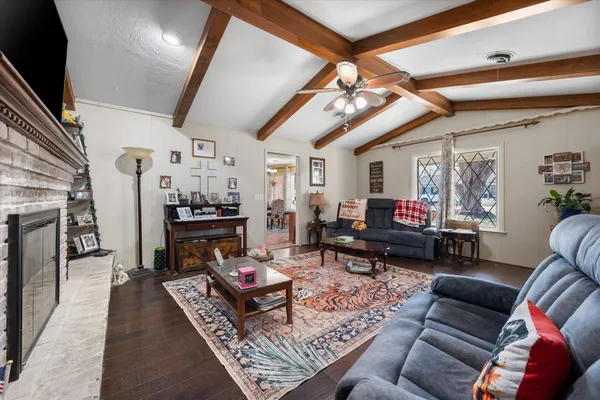 a living room with lots of furniture and kitchen view