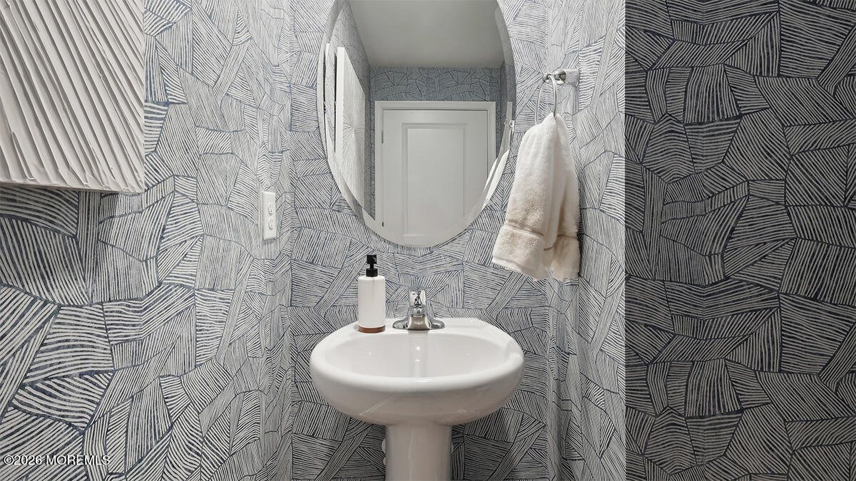 445 Ridge Avenue Hamilton, NJ 08610 - Photo 15 of 33 a bathroom with a sink a mirror and shower