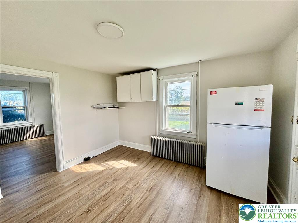 4067 Newburg Road Bethlehem, PA 18020 - Photo 10 of 19 Warm wood flooring and classic radiator heating define this functional kitchen space.