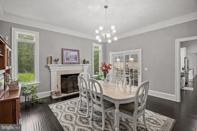a view of a room with wooden floor and a bathroom