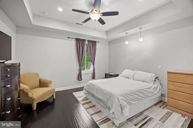 a living room with a flat screen tv and gym equipment