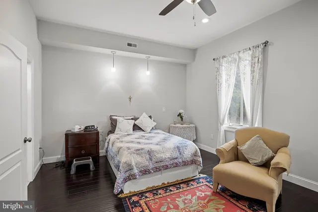 a living room with lots of chairs and chandelier