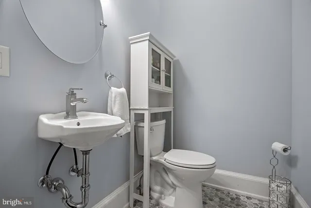 a kitchen with stainless steel appliances granite countertop a stove a refrigerator a sink a stove and white cabinets with wooden floor